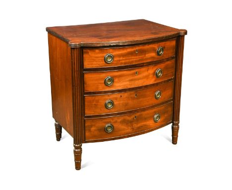 A small bow fronted mahogany chest of four drawers, 19th century, the graduated drawers flanked by reeded pilasters raised on
