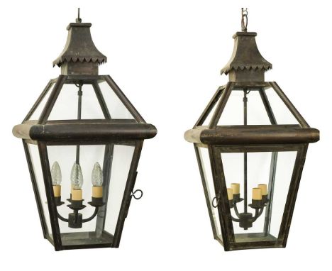 A pair of four light brass hanging hall lanterns, early 20th century, each four sided, with glass panels and hinged door66 x 