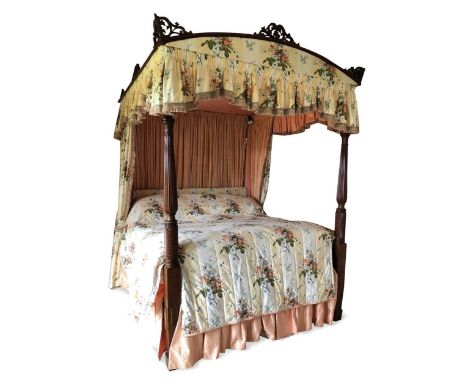 A Regency style mahogany tester bed, the reeded and leaf carved front posts supporting a shaped canopy with pierced decoratio