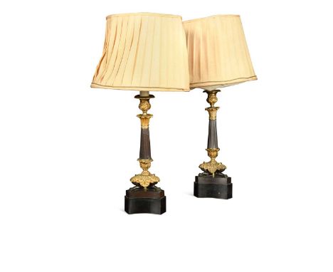 A pair of Regency style bronzed and gilt metal triform candlestick lamps, 20th century,  with reeded columns on trefoil suppo