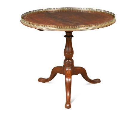 A circular mahogany silver table, circa 1800, the tilt-top with pierced brass gallery above a turned column with tripod base7