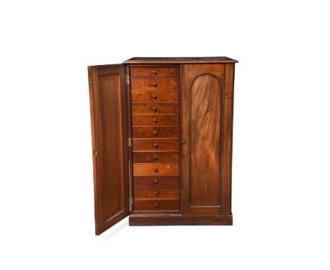 A Victorian mahogany collector's cabinet, with two arched panel doors enclosing two banks of small drawers99.5 x 65 x 47cm