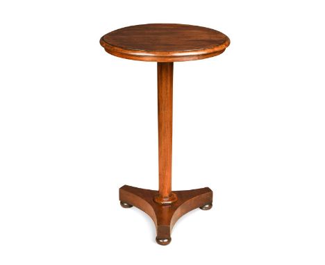 A William IV mahogany pedestal lamp table, the circular top above an octagonal tapering column and tripartite base76 x 47cm d