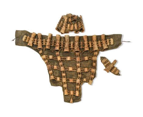 A Tibetan three piece carved bone ritual apron set, probably circa 1900, each cloth-backed item mounted with bones carved wit