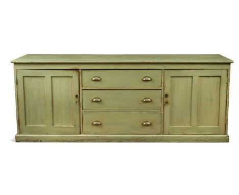 A late Victorian green painted pine kitchen dresser, the rectangular top over three long drawers flanked by cupboards on a pl