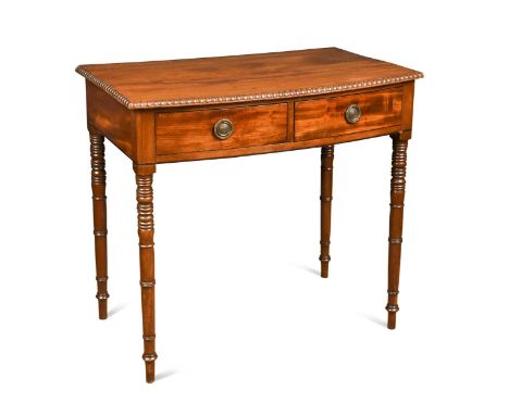 A late Regency mahogany bow front side table, the top with moulded edge over two frieze drawers raised on ring turned legs79.