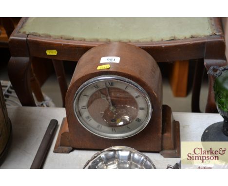 An oak single hole mantel clock