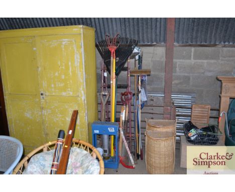 A large quantity of long handled gardening tools; a metal step ladder and a greenhouse heater