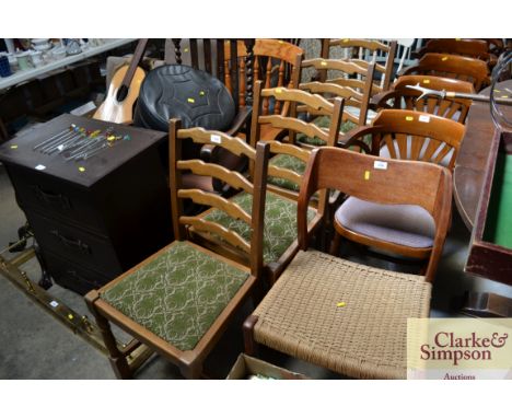 A set of four oak ladder back dining chairs