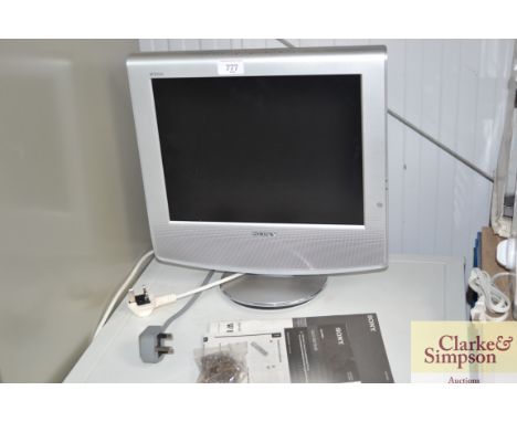 A Sony flat-screen TV with instruction manual 