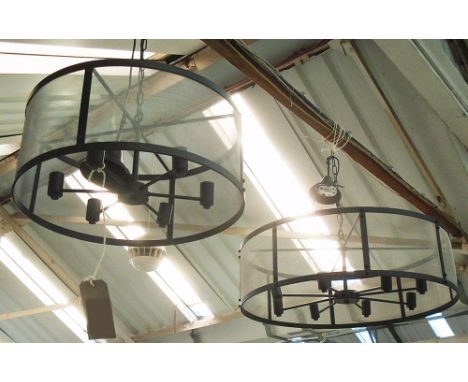 HANGING LIGHTS, two, eight branch and six branch circular in black frames, 86cm diam. and 69cm diam., both 27cm H plus chain.