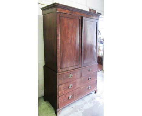 LINEN PRESS, George III mahogany with a pair of panelled doors above enclosing a hanging rail over two short and two long dra