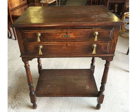 A Harrods canteen of cutlery (some pieces missing) in a Harrods oak 2 drawer cabinet with turned legs, approx 64x79cm.