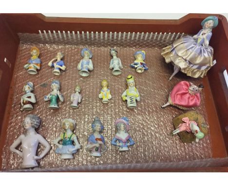 A collection of 17 ceramic half dolls to include full bodied clothes.