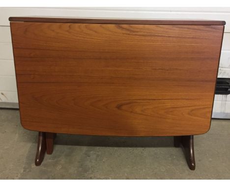 An Ercol / G-Plan style drop leaf gate leg dining table.