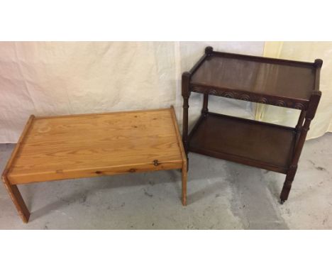 A modern pine coloured coffee table together with a dark wood vintage tea trolley with carved front.