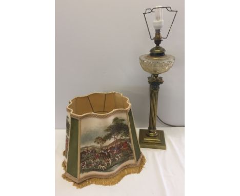A Victorian heavy brass column design oil lamp with cut glass bowl (has been converted to electric) with vintage hunting scen