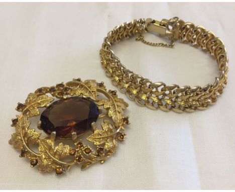 2 pieces of vintage Sarah Coventry costume jewellery comprising: 1. Goldtone oval brooch with leaf design mount set with deep