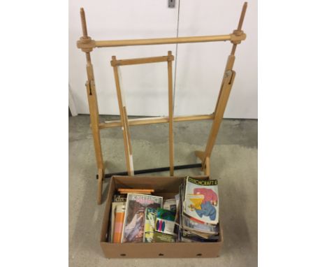 A box of vintage knitting patterns and sewing books together with a wooden embroidery work frame.