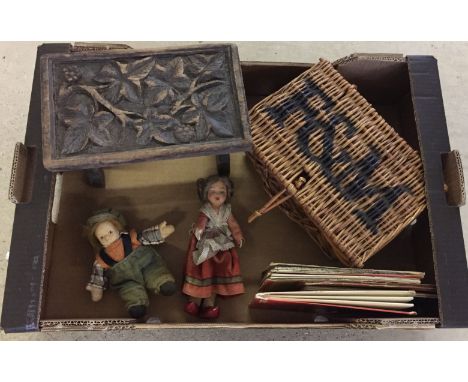 A box of misc items comprising: Carved stool, vintage ordinance survey maps, small Fortnum & Masons wicker hamper and dolls.