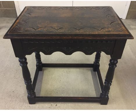 A vintage oak occasional table with carved detail to front and top.