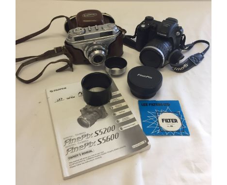 A Fuji digital fine pix 55600 camera with wide conversion lens and Volgtlander arette in need of repair.