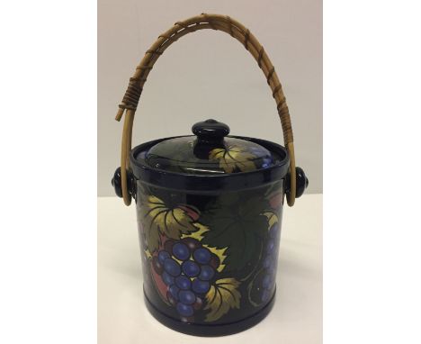 A ceramic Stanley Ware biscuit barrel with grape vine decoration.