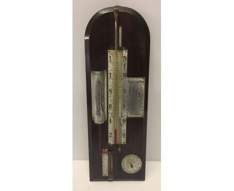 A vintage bar thermometer on wooden mount.