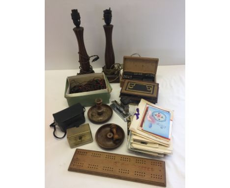 A box of misc items to include wooden lampstands, bakelite Christmas lights and vintage Christmas cards.