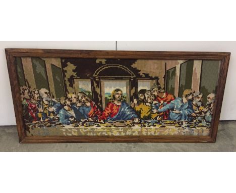 A framed tapestry depicting The Last Supper. Approx 42 x 93cm.