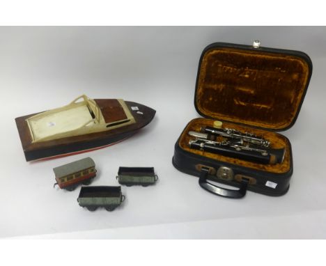 A clarinet with fitted case together with tin plate 0 gauge railway track and model boat (a collection).