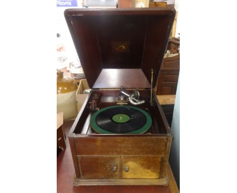 A vintage HMV wind up table top and mahogany cased gramophone.