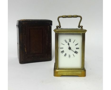 A French brass cased carriage clock with platform escapement, key and travel box.
