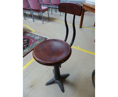 Singer Sewing machinist stool with cast iron base and marked 'Singer' to each foot.