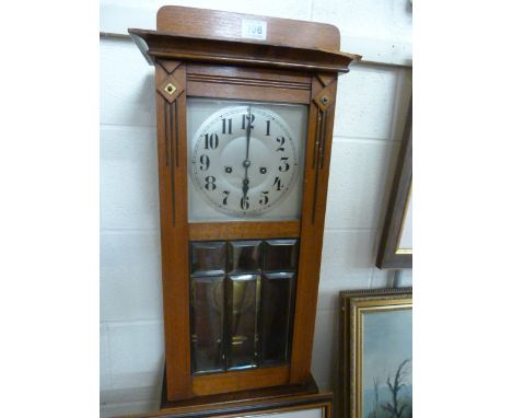 Antique mahogany wall clock Some damage. With bevelled glass door. Key and Pendulum in office