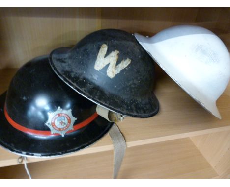 Devon County Fire and Rescue Service metal helmet and two other warden helmets - 2 shelves