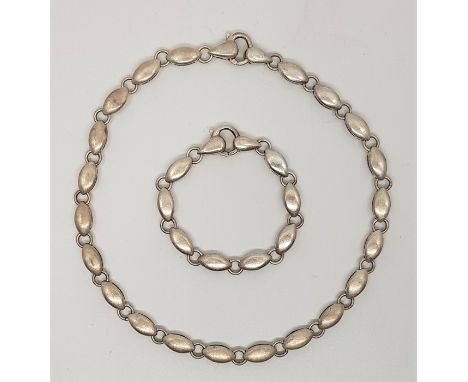 A collection of modernist silver jewellery, to include; a silver necklace and bracelet en suite, each fashioned from brushed 