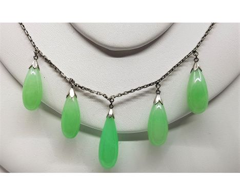 A white gold and jade fringe necklace, the box link chain suspending fringe of five polished green jade drops, clasp stamped 