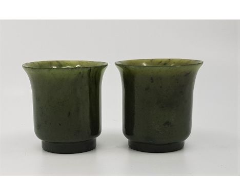 A pair of small Chinese spinach jade cups, with out-swept rims, each height 5.2cm. (2)&nbsp;&nbsp;