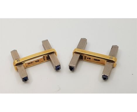 A pair of 18ct. white and yellow gold and sapphire cuff links, the front and bullet back fitting of engine turned white gold 