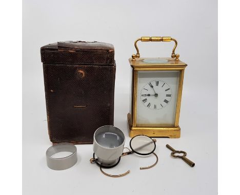 An R &amp; Co. (Paris) cased brass carriage clock, with key in working order, together with a pair of watchmakers glasses, (2