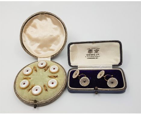 A pair of 9ct. yellow gold, mother of pearl and sapphire set cuff links, of circular form with domed backs and carved mother 