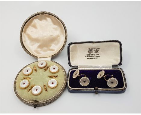 A pair of 9ct. yellow gold, mother of pearl and sapphire set cuff links, of circular form with domed backs and carved mother 