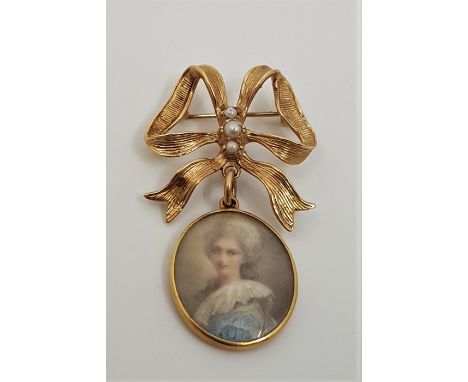 A 19th century oval portrait miniature pendant, of a lady wearing a blue and white dress, watercolour, under glass within pre