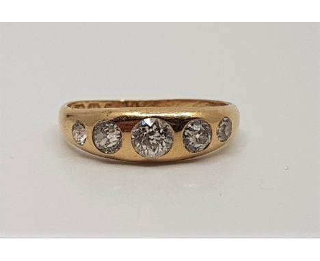 An 18ct. gold five stone gypsy set diamond ring, set graduated old cut diamonds, assayed Birmingham 1924. (gross weight 3.1g)