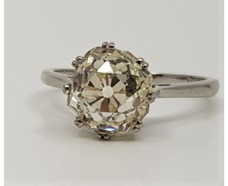 A platinum diamond solitaire ring, claw set old cut diamond (assessed diamond weight approx. 3.20 carats, colour M-Z, yellow 