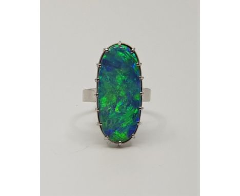 An 18ct white gold opal ring, claw set large ovoid opal cabochon, (gross weight 8.1g)Size: UK O.