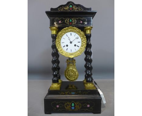 A late 19th century French clock, having a white Roman dial, the inlaid architectural ebonised case with barley twist columns