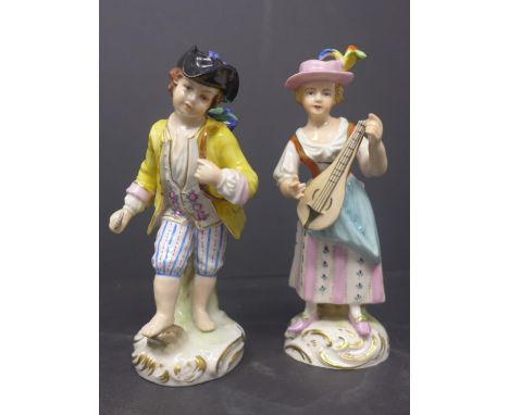 A pair of West German porcelain figurines by Martha Budich of a woman playing the lute and a man carrying a basket of flowers