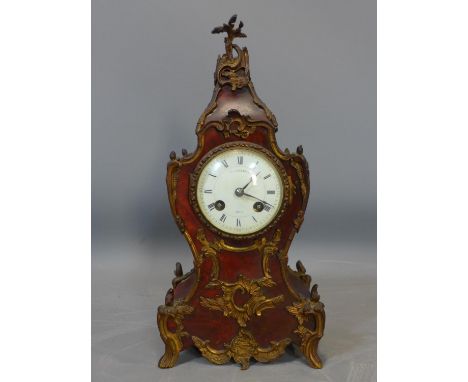 A late 19th century French mantle clock by Maple &amp; Co. Ltd, decorated with ormolu mounts, the white enamel dial with Roma